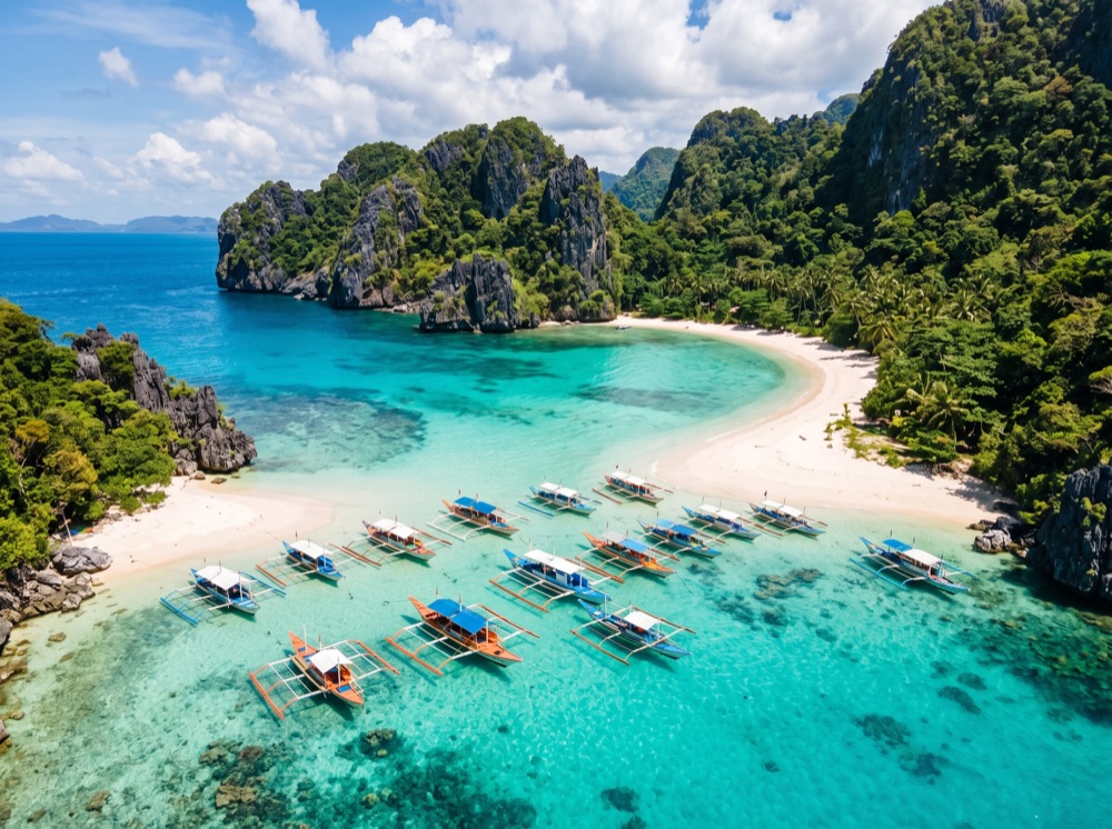 Outrigger boats in turquoise water at a Philippine island beach